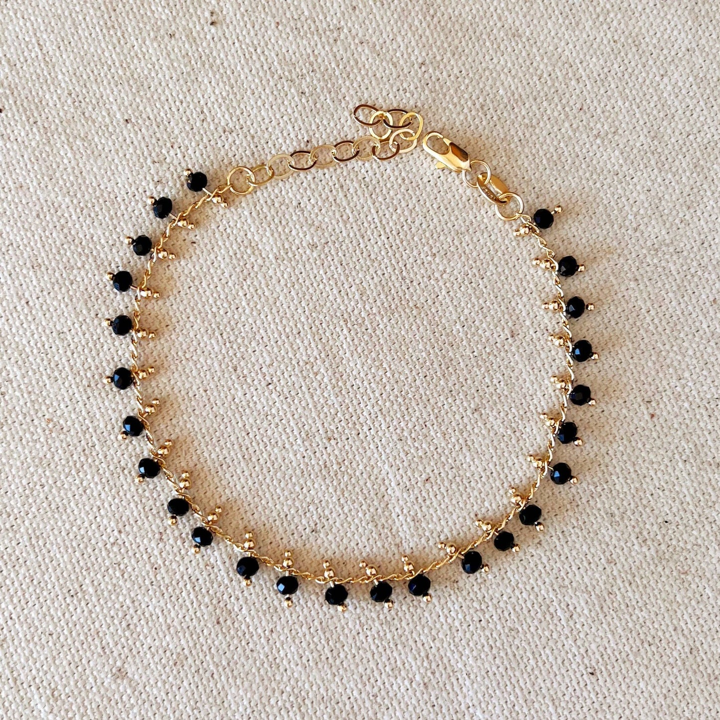 Bracelet en perles noires remplies d'or 18 carats